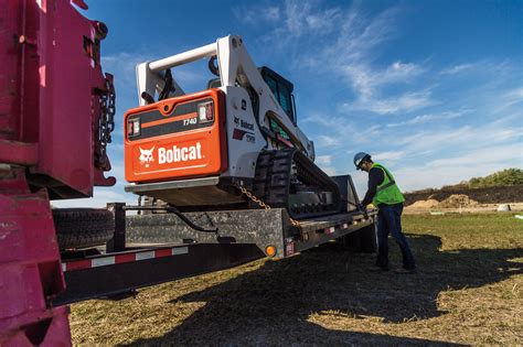 how to load skid steer onto a box truck|bobcat loading on trailer.